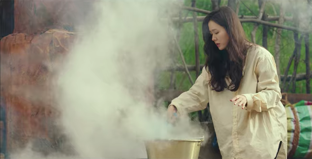 Se-ri getting hot water from the cauldron in Captain Ri's backyard Se-ri getting hot water from the cauldron in Captain Ri's backyard